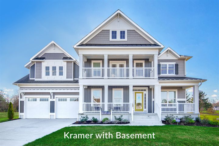 The Kramer at 30226 Snug Berth Drive: two-story coastal home with double front porches and a three-car garage